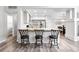Kitchen with wooden countertops, pendant lighting, three bar stools, and stainless steel appliances at 10010 E Gunnison Pl # 707, Aurora, CO 80247