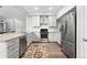 Renovated kitchen with wooden countertops, stainless steel appliances, and white cabinetry at 10010 E Gunnison Pl # 707, Aurora, CO 80247