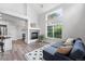 Spacious living room with a fireplace, large window, and comfortable seating area at 10010 E Gunnison Pl # 707, Aurora, CO 80247