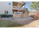The backyard boasts a built-in stone gas grill, a landscaped yard, and an open and covered deck at 338 Sage Grouse Cir, Castle Rock, CO 80109