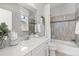 Bright bathroom features a tiled shower and tub, with a vanity and decorative accents at 338 Sage Grouse Cir, Castle Rock, CO 80109
