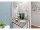 Modern powder bath with blue tiled wall, granite countertop and decorative accents at 338 Sage Grouse Cir, Castle Rock, CO 80109