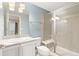 Bathroom featuring a tiled shower with a glass door, single sink vanity, and neutral colors at 338 Sage Grouse Cir, Castle Rock, CO 80109
