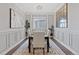 Sophisticated dining space with wainscoting, decorative mirror, and a stylish area rug at 338 Sage Grouse Cir, Castle Rock, CO 80109