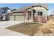 Charming home featuring stone accents, three-car garage and a welcoming entrance at 338 Sage Grouse Cir, Castle Rock, CO 80109