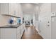 Galley kitchen featuring white cabinets, granite countertops and hardwood floors at 338 Sage Grouse Cir, Castle Rock, CO 80109