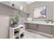 Bright laundry room with ample shelving, storage baskets, decorative plant, and art for functional elegance at 338 Sage Grouse Cir, Castle Rock, CO 80109