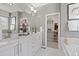 Bright main bathroom with dual sinks, walk-in closet, and luxurious modern finishes at 338 Sage Grouse Cir, Castle Rock, CO 80109