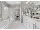 Spa-like bathroom with soaking tub, glass shower, dual vanities, and elegant tile flooring at 338 Sage Grouse Cir, Castle Rock, CO 80109