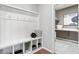 Organized mudroom with bench seating, coat hooks, and direct access to the laundry area at 338 Sage Grouse Cir, Castle Rock, CO 80109