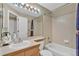 Bathroom with shower over tub, single vanity sink, and large mirror at 10877 W 55Th Ln, Arvada, CO 80002