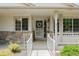 Inviting front porch featuring decorative wreath and stone accents around the entryway at 10877 W 55Th Ln, Arvada, CO 80002