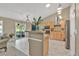 Spacious kitchen with stainless steel appliances, tile countertops, and access to outdoor deck at 10877 W 55Th Ln, Arvada, CO 80002