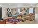 Inviting living room with neutral colors, comfortable seating, and a stylish area rug at 10877 W 55Th Ln, Arvada, CO 80002