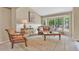Bright living room featuring large bay windows and classic furnishings at 10877 W 55Th Ln, Arvada, CO 80002