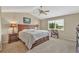 Bedroom featuring a large bed, wood furniture, carpet, and window with natural light at 10877 W 55Th Ln, Arvada, CO 80002