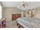 Spacious bedroom with a large bed, wood furniture, carpet, and access to an ensuite bathroom at 10877 W 55Th Ln, Arvada, CO 80002