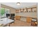 Bright office space featuring built-in shelving and a large window for natural light at 10877 W 55Th Ln, Arvada, CO 80002