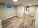 Basement featuring durable vinyl flooring, neutral walls, bathroom vanity, and a window with natural light at 8307 E 14Th Ave, Denver, CO 80220