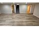 Finished basement area with plank flooring, neutral paint, and access to staircase at 8307 E 14Th Ave, Denver, CO 80220