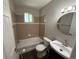 Neutral bathroom featuring a shower over bath and a modern vanity at 8307 E 14Th Ave, Denver, CO 80220
