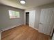 Bedroom with hardwood floors, neutral walls, and a closet with sliding doors, all illuminated by a modern ceiling light at 8307 E 14Th Ave, Denver, CO 80220