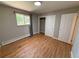 Cozy bedroom featuring hardwood floors, closet, a window letting in natural light, and neutral paint at 8307 E 14Th Ave, Denver, CO 80220