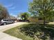Charming home with a lush front yard, mature tree, and driveway parking at 8307 E 14Th Ave, Denver, CO 80220