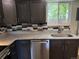 Updated kitchen featuring granite countertops, stainless steel appliances, and a modern backsplash at 8307 E 14Th Ave, Denver, CO 80220