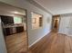A view of the kitchen with stainless steel appliances and wood flooring from the living area at 8307 E 14Th Ave, Denver, CO 80220