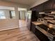 Modern kitchen boasts stainless steel appliances, dark wood cabinets, and an open design at 8307 E 14Th Ave, Denver, CO 80220