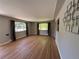 Bright living room featuring hardwood floors, neutral walls, and windows with views of the neighborhood at 8307 E 14Th Ave, Denver, CO 80220