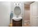 Bathroom featuring a sink with vanity and mirror, with a view through the door into another room at 14791 E Poundstone Dr, Aurora, CO 80015