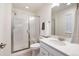 Bathroom featuring a glass-enclosed shower, white vanity, and a large mirror at 14791 E Poundstone Dr, Aurora, CO 80015