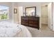 Bedroom with dresser, mirror, window and door to closet and door to the rest of the home at 14791 E Poundstone Dr, Aurora, CO 80015