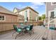 This deck features a dining table with seating for four and views of the surrounding neighborhood at 14791 E Poundstone Dr, Aurora, CO 80015