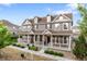 Charming two-story home with covered front porch and manicured landscaping at 14791 E Poundstone Dr, Aurora, CO 80015