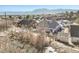 An aerial view shows the fenced in backyard with a playset and mountain views in the distance at 819 Meadow Ln, Palmer Lake, CO 80133