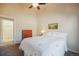 Bedroom features gray carpet, ceiling fan, neutral walls, and access to the hallway at 819 Meadow Ln, Palmer Lake, CO 80133