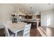 Open floor plan with kitchen and dining area with chandelier and vaulted ceiling at 819 Meadow Ln, Palmer Lake, CO 80133