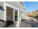 Patio area showcasing sliding door access, stylish gray siding, and charming exterior details at 819 Meadow Ln, Palmer Lake, CO 80133