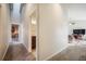 Hallway view featuring carpeted floors, a high vaulted ceiling and a view of the living room at 819 Meadow Ln, Palmer Lake, CO 80133