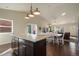 Kitchen with island connects to dining room and living room in open concept design at 819 Meadow Ln, Palmer Lake, CO 80133