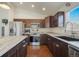 Updated kitchen featuring stainless steel appliances, marble countertops, and dark wood cabinets at 819 Meadow Ln, Palmer Lake, CO 80133