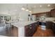 Kitchen with large island, stainless steel appliances and open floor plan for dining and living area at 819 Meadow Ln, Palmer Lake, CO 80133