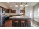 Kitchen with a center island with seating and a pantry behind sliding doors at 819 Meadow Ln, Palmer Lake, CO 80133