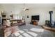 Open-concept living room with a fireplace and large windows, perfect for relaxation and entertainment at 819 Meadow Ln, Palmer Lake, CO 80133