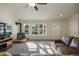 Bright and airy living room featuring a fireplace and multiple windows offering scenic views at 819 Meadow Ln, Palmer Lake, CO 80133