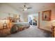 Bright main bedroom with fan, light colored carpet, and sliding glass doors to the patio at 819 Meadow Ln, Palmer Lake, CO 80133