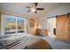 This main bedroom features a ceiling fan, decorative dresser, and sliding barn door to the bathroom at 819 Meadow Ln, Palmer Lake, CO 80133